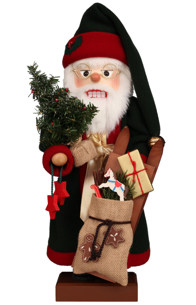 Christian Ulbricht Collectible Wooden Nutcracker - Santa with Christmas Gifts, shaped like Santa holding a small Christmas tree, a burlap sack filled with gifts, a wooden sled, and a toy horse.