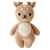 A hand-knit Cuddle + Kind Baby Fawn toy, crafted from soft Peruvian cotton yarn with white accents on its belly and face, featuring stitched eyes and a nose, and small antlers on top.
