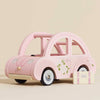 The Maileg Road Trip Adventure Set features a pink wooden toy car with floral details and a matching suitcase labeled "Sophia," all set against a light beige background—ideal for dolls' house play or as charming nursery decor.