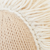 Close-up of the Cuddle + Kind Baby Pony, highlighting its thick knit stitches and cream-colored fringed threads made from Peruvian cotton yarn, showcasing the plush texture and intricate handcrafted detail.