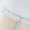 Close-up of Cuddle + Kind Beatrice The Mouse - Periwinkle, featuring textured cream and light blue knits separated by a decorative edge, showcasing the intricate stitching and soft materials used in this sustainable, fair trade handmade doll.