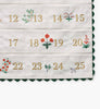 Nativity Embroidered Hanging Advent Calendar featuring embroidered numbers 12 through 25 and small floral motifs between each digit.