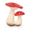 Spot the Mushroom Teething Toy features two red and white spotted mushrooms with cream-colored stems joined at the base. Made from natural rubber, this slightly cartoonish baby toy is perfect for teething and sensory play.