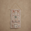 Coral & Tusk Holiday House Advent Calendar wall hanging featuring an embroidered illustration of a multi-story home with twenty-four small pockets across windows and balconies.
