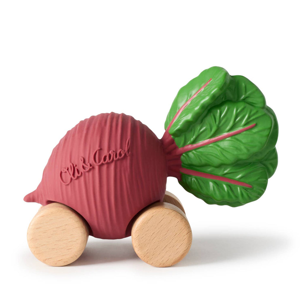 Betty The Beetroot Baby Car is a beetroot-shaped toy with green leaves, red body, and four wooden wheels. Made from FSC-certified wood and natural rubber, it features "Oli & Carol" embossed on the side for an eco-friendly playtime.