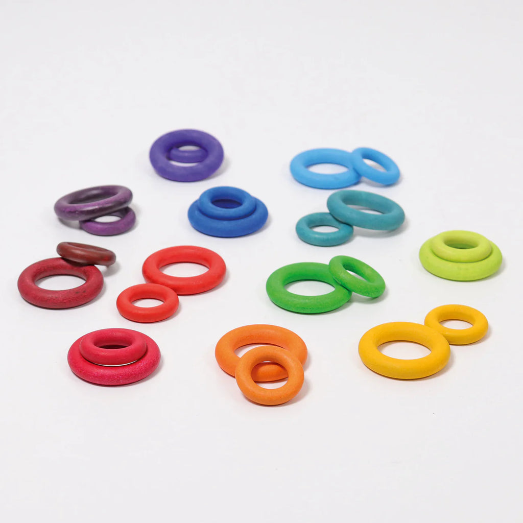 Grimm's Building Rings - Rainbow features assorted colorful wooden stacking toy rings in purple, blue, green, yellow, orange, and red—perfect for building and developing fine motor skills.