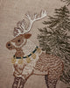 The Coral & Tusk Christmas Cheer Wreath Pillow features an embroidered reindeer wearing a collar with gold bells, standing next to an evergreen tree.