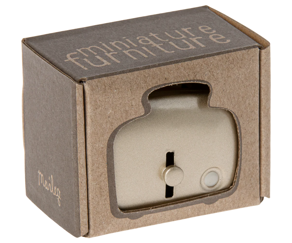 The Maileg Toaster with Bread, Large Size - Silver, is a charming metal toy toaster for kids, packaged in a brown box with a cut-out window that showcases the toaster and features "miniature furniture" printed on the top.