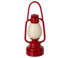 The Maileg Lantern, part of the Maileg Camping Set, is a red decorative lantern with a smooth, egg-shaped center in cream. It features a rounded base and tall, curved handle, ideal for adorning your Maileg Bonfire Set or lighting up your cozy Maileg Tent.