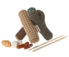 The Maileg Camping Set includes three soft toy logs in a pyramid shape, like a bonfire, two chew sticks with white ends, and assorted colorful bone and roll treats. Perfect for sparking your pup's sense of adventure!.