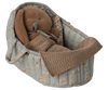A plush brown bunny toy wearing silver sunglasses lies under a textured brown blanket with toy bedding, resting in a soft, padded Maileg Carry Cot, Large - Blue, featuring a quilted floral pattern.