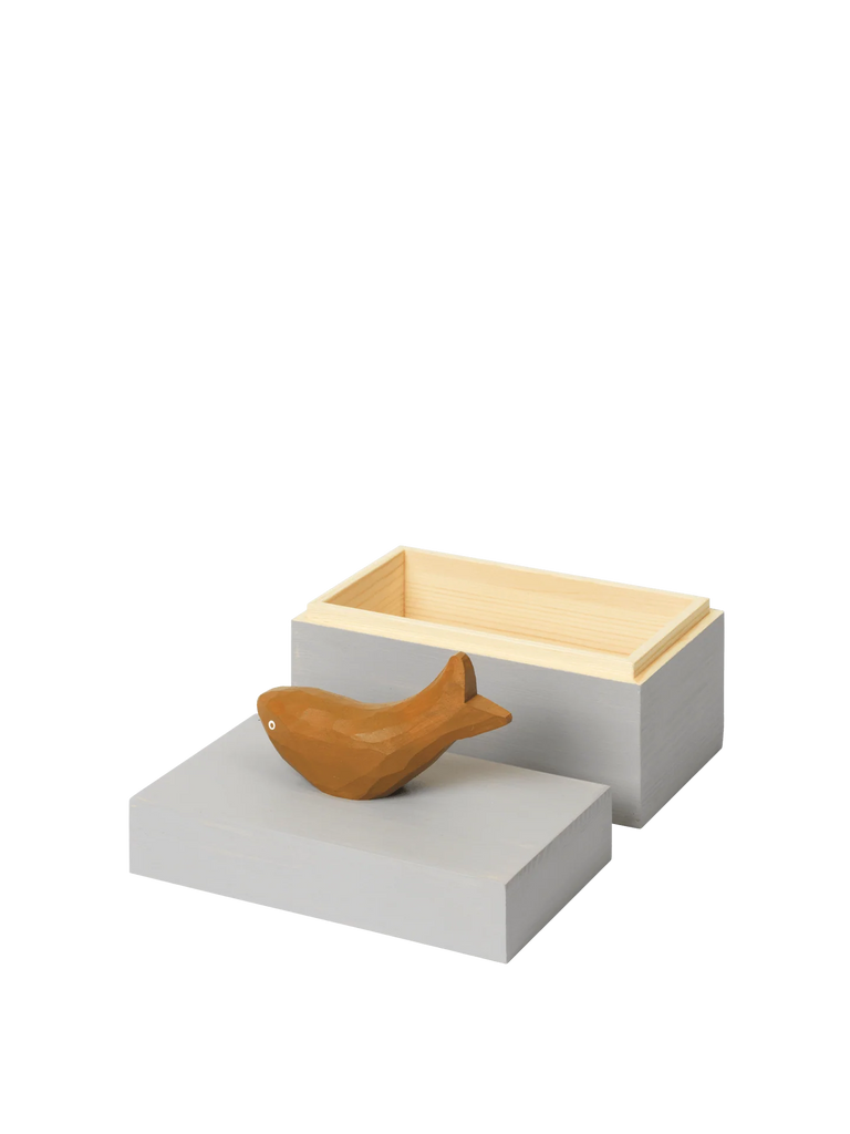 The Ferm Living Hand Carved Wooden Harbour Box - Fish features a wooden fish figurine on its rectangular, light gray lid with a natural wood interior—an ideal decorative touch for any children's room.