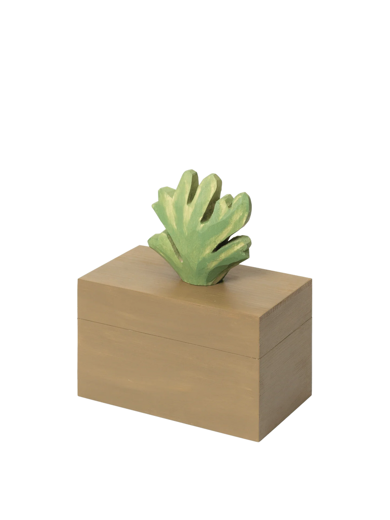 The Ferm Living Hand Carved Wooden Harbour Box - Coral is a rectangular children’s storage box crafted from FSC certified aspen wood with a smooth, light brown finish and topped with a coral-colored decorative piece.