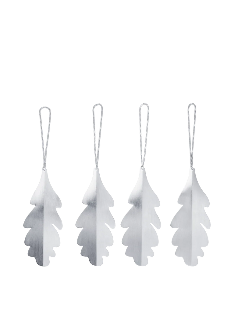 Four silver-colored metal Ferm Living Oak Leaf Ornaments - Set of 4 - Silver, each hanging from a loop of string.