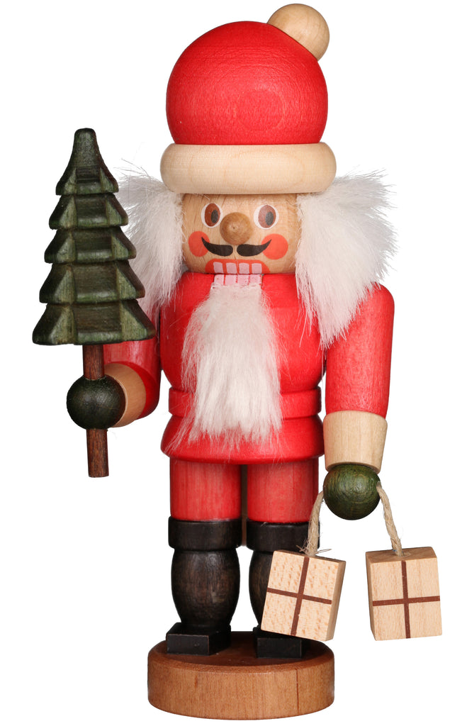 The Christian Ulbricht Collectible Wooden Nutcracker - Mini Santa, made in Germany, features a red suit, white beard, and holds a small green Christmas tree and two gift boxes—perfect for festive holiday décor.