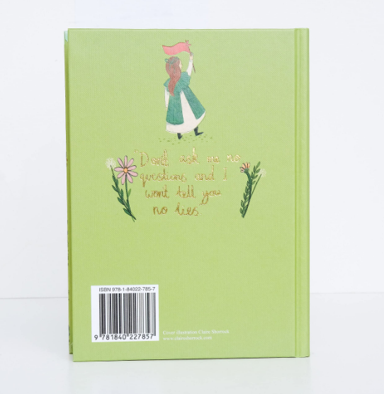 The back cover of The Railway Children | Collector's Edition | Hardcover features a girl with a pink flag above gold-embossed text, "Don't ask me no questions and I won't tell you no lies," bordered by flowers.