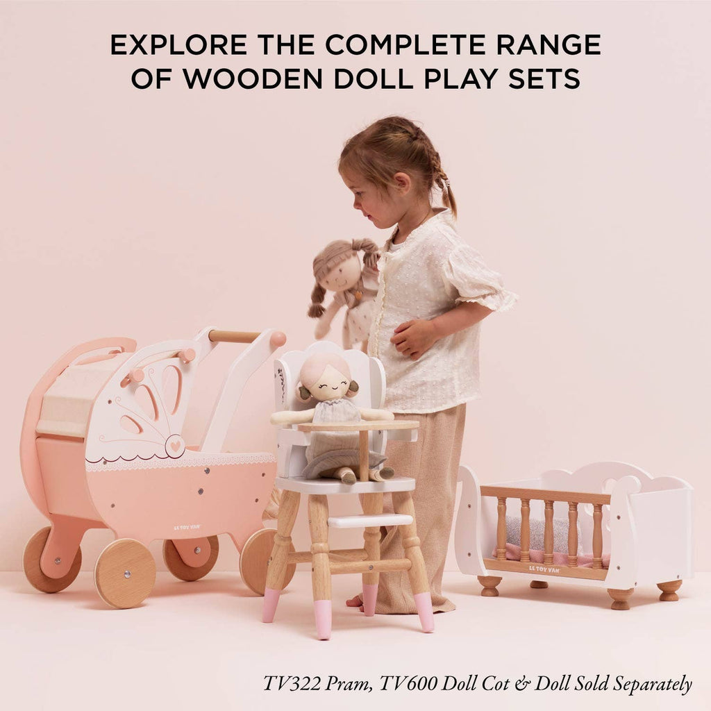 A child enjoys pretend play with Dolls Wooden High Chair, a pink pram, and a white cot. Text above says, "Explore the complete range of eco-friendly toys for pretend play fun.