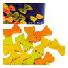 Colorful wooden pieces shaped like farfalle pasta are scattered on a white surface, with an Erzi Farfalle Pasta Pretend Food tin—featuring images of farfalle and "100% Holz"—in the background.