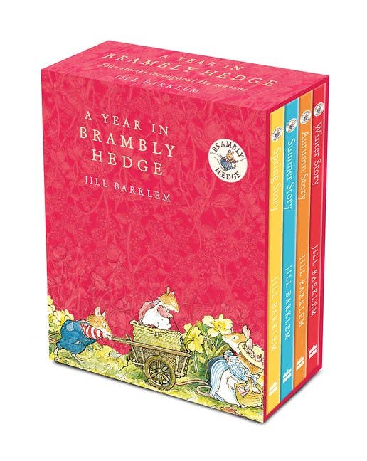 A Year In Brambly Hedge by Jill Barklem is a boxed set featuring four classic tales, with a red box illustrated with mice in clothing and pastel-colored spines displaying the titles of these beloved adventures.