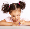 A young girl paints her fingernails with a small bottle of Klee Kids Water-Based Nail Polish Set - Starry Sky Kiss.