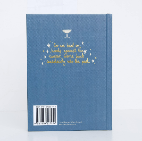 The back cover of The Great Gatsby | Collector's Edition | Hardcover is blue, featuring a white cocktail glass above a gold-foil quote. A barcode and ISBN appear at the bottom left—an essential for classic American literature enthusiasts.