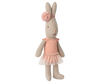 A Maileg Rabbit, Micro wears a rose ballet suit and skirt, standing upright like a tiny dancer against a blurred striped background.