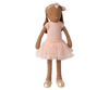 The Maileg Bunny, Size 3 in Chocolate Brown, wears a rose ballet suit and skirt, standing against a striped, blurred background.