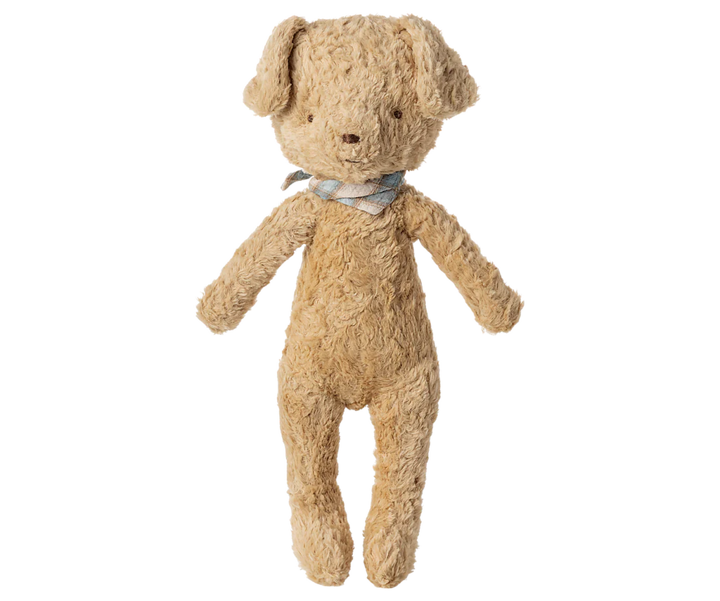 The Maileg Poodle Dog, Vintage Plush in Soft Sand stands upright against a plain background, featuring a textured light brown design and a blue and white plaid bow around its neck.