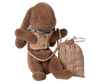 The Maileg Sleeping Bunny Supply, Harness features a plush brown bunny in a tan vest and gray scarf, holding a harness leash set attached to a striped fabric bag.