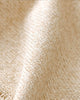 Close-up of Cuddle + Kind Organic Cotton Baby Bear Lovey in Honey, showing its soft, textured beige weave and visible fibers—perfect as a fair trade baby gift or cozy organic comfort item with gentle folds and shadows.