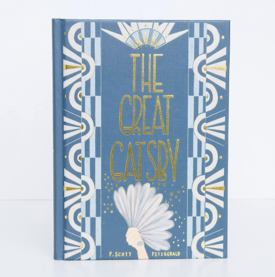 The Great Gatsby | Collector's Edition | Hardcover comes in blue and white with gold art deco designs and a person holding a white fan on the cover—a stunning choice for American literature enthusiasts.