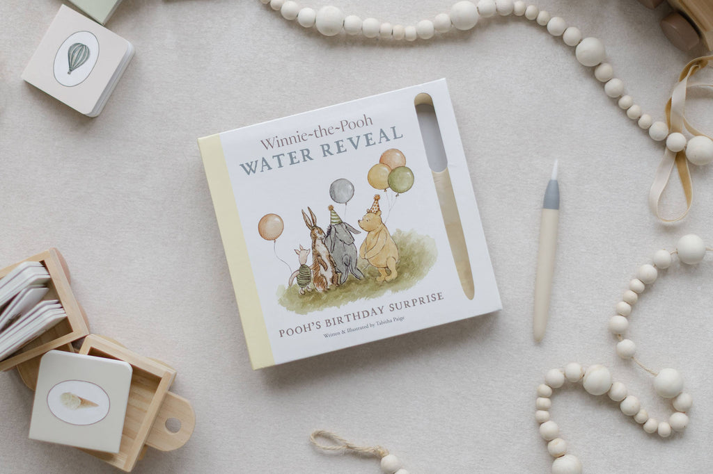 Winnie-the-Pooh: Pooh’s Birthday Surprise (Water Reveal) book featuring Pooh and his friends with balloons, a water pen, wooden beads, and small illustration cards for a no-mess activity.
