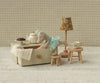 The Maileg Dance Mouse in Daybed, Little Sister - Mint wears a mint dress and lounges on her daybed, surrounded by miniature furniture and accessories for a charming, whimsical play scene.