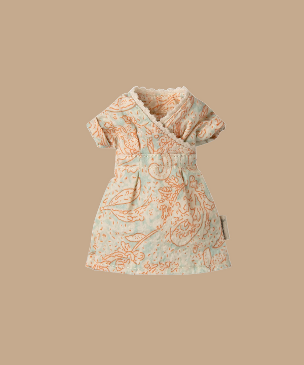 The Maileg Dress For Mum Mouse is a chic, intricately patterned dress with short sleeves and a wrap-style design, featuring a blue and orange paisley print on solid beige—perfect for your little one's wardrobe. Ships in one week.