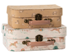 The Maileg Suitcase Set, 2-Pieces - Unicorn, includes two decorative cases: the top is light brown with white flowers, while the bottom features unicorns, trees, rainbows, and is finished with light pink handles and brass clasps.