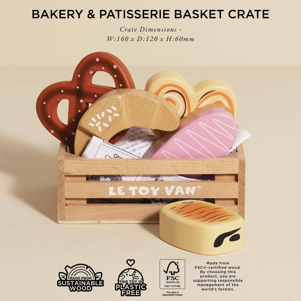 The Bakery & Patisserie Wooden Market Crate includes eco-friendly, plastic-free wooden toy pastries—pretzel, croissant, heart cookies, and a pink-frosted treat—in a charming crate labeled "LE TOY VAN" with dimensions provided for pretend bakery play.