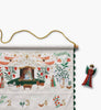 A Nativity Embroidered Hanging Advent Calendar featuring embroidered nativity scenes and numbering, displayed alongside a matching angel ornament.