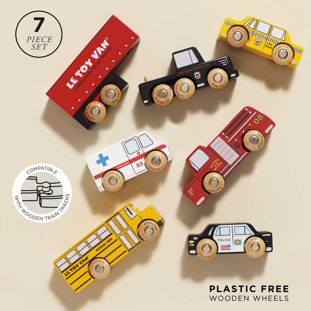 The American Wooden Car Set includes seven colorful vehicles—a red van, black truck, yellow taxi, school bus, ambulance, fire truck, and police car. Plastic-free and compatible with wooden train sets for imaginative play.