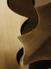 Close-up of overlapping brass Ferm Living Holly Leaf Ornaments - Set of 4 - Brass used for holiday décor.