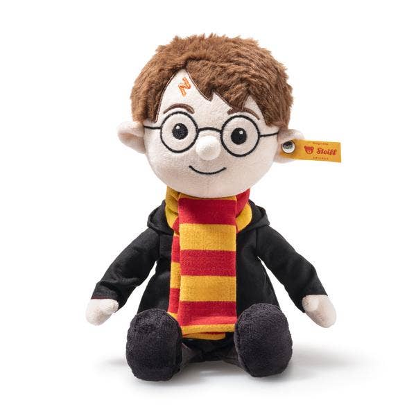 A Steiff Harry Potter Plush 11" featuring a boy with round glasses, lightning bolt scar, brown hair, red and yellow scarf, black robe, and a yellow Steiff tag on his left ear.