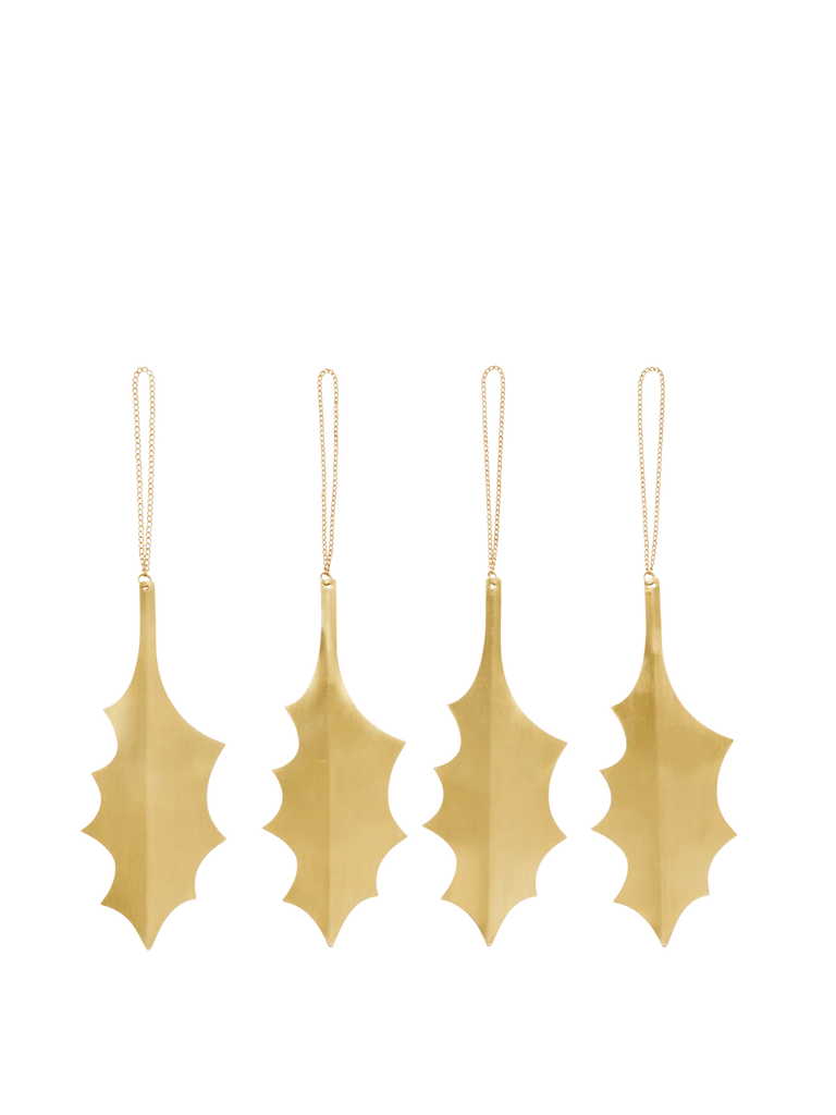 A set of four metallic Ferm Living Holly Leaf Ornaments - Set of 4 - Brass hanging from thin chains.