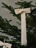 Two frayed, handmade organic cotton Ferm Living Bow Decoration - Small - Set of 2 - Natural bows hanging from a pine tree branch.