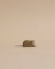 A Handmade Holzwald Mouse figurine with a metallic tail, crafted in the shape of a heart, set against a plain beige background. This piece is one of our sustainable toys.