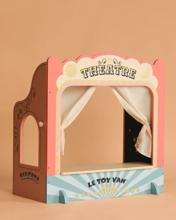 The Tabletop Puppet Wooden Theater is a charming wooden play theater with pastel colors, "THEATRE" at the top, "LE TOY VAN" below, and a side "TICKETS" sign on a light brown background—perfect for imaginative play.