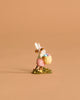 The Wee Forest Folk Tiny Collectible - Hoppy Easter Girl (Not a Toy) features a handmade mouse in a pink dress with bunny ears, holding a basket of pastel eggs on grass—a delightful piece for collectors.