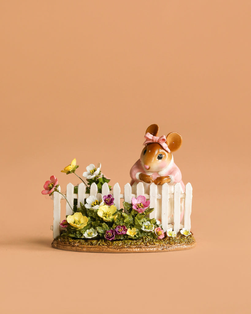 Annette's Garden: This Wee Forest Folk Tiny Collectible features a hand-sculpted mouse with a pink bow behind a white picket fence and vibrant flowers—an adorable addition to any miniatures collection.