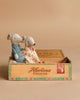 Two Maileg mice dressed as Grandma and Grandpa sit together in a vintage wooden cigar box labeled “Havana Cigars” against a plain beige background, surrounded by charming accessories from the Maileg Kitchen Set.