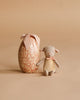 The Maileg Easter Egg with Micro Lamb, Small - Powder, features a cute micro lamb and comes in a decorative egg-shaped box with a bow—an adorable gift for children.