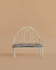 The Maileg Vintage Bench, Miniature - Off White features a decorative backrest and a light blue floral cushion, ideal for displaying Maileg bunnies or teddy bears against any background.