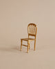 A miniature gold Maileg Dining Set Set mouse-size dining chair with a spindle back and textured seat.